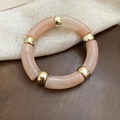 Detail of peach pink acrylic resin segments and gold metal beads on a beaded bracelet - Peach Pink (Translucent Pattern)