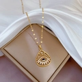 Titanium steel gold necklace with teardrop Eye of Horus pendant on white silk fabric - E534 Titanium Steel Chain Copper Pendant
