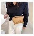 Detail of khaki leather waist bag with unique geometric flap and square buckle on model - Khaki