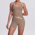 Detail of high-waist yoga shorts with cross V-cut design and white contrast trim in coffee color - S / Cocoa Brown