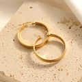 Minimalist large golden hoop earrings in titanium steel on a natural stone tray - Minimalist Polished Large Hoop Style (E129)