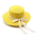 Detailed close-up of yellow straw sun hat with white lace ribbon and bow decoration - M (56-58cm) / Yellow
