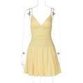 Detailed view of yellow V-neck dress featuring pleated waist and ruffled hemline - M / Yellow