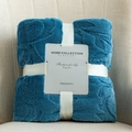 Light blue jacquard flannel blanket folded with elegant white ribbon and a product card - Aqua Blue