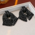 Detailed view of luxurious black rhinestone drop earrings on a premium leather jewelry tray - Bowknot Earrings / Black