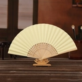 DIY 6-inch cream folding paper fan with carved bamboo ribs on a wooden stand - Light Yellow
