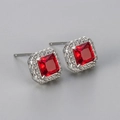 Macro view of square red zircon stud earrings with silver plating and halo diamonds - Silver Red