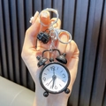 Miniature black alarm clock keychain with metal ring and bell accessory hand-held view - Black