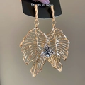 Detailed view of oversized golden hollow leaf earring with silver floral centerpiece accent - Silver Pin Gold Leaf Butterfly (HE28793)