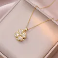 Rotating gold clover necklace featuring pavé white zircons on a luxury silk cushion - X3167 Gold Heart Rotating