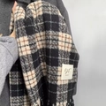 Winter plaid scarf with tassels in black and caramel colors and woven brand label - Black and White Plaid