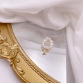 Detail of freshwater pearl ring with golden letter A charm on a vintage mirror - Letter A