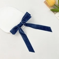 Elegant navy blue velvet bow hair clip with long ribbons on a white decorative ceramic plate - Dark Blue
