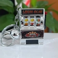 Mini silver slot machine keychain with a red handle and functional lucky spin wheels - Silver Slot Machine With Silver Lobster Clasp And Bell / 50 Batches