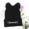 Detail of black knit beanie with plush cat ears and white embroidered whiskers - Black
