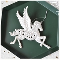 Close-up of white glitter pegasus ornament on a green tray for Christmas decor - Pegasus