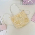 Close-up of yellow checkered bag with rose lace overlay and pearl chain strap details - Yellow