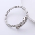 Detailed view of silver stainless steel twisted cable bangle with smooth metal end caps - Silver
