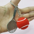 Detail of creative red tennis ball and silver racket keychain pendant on a pink background - 3.8cm Ball / Red