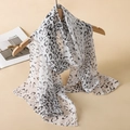 Elegant long chiffon scarf with classic black and white leopard print on wooden hanger - Black and White Leopard Print