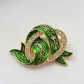 Close-up of green enamel brooch with gold base and clear crystals in floral design - Swirl Floral Style (B)