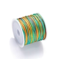 Macro shot of gradient colorful braided jewelry cord on white spool for DIY crafts - Color No. 11