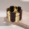 Bracciale chic in acrilico geometrico con metallo dorato e moduli in resina marrone - caffè