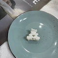 Cute white matte bear-shaped hair claw clip in a minimalist blue plate setting - Creamy White