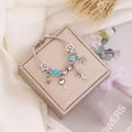 Detailed view of a silver snake chain bracelet with rainbow and fairy enamel charms - 1# Blue