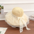 Beige straw sun hat featuring a large lace bow and elegant wide brim for beach vacations - New Flower Lace Beige