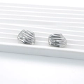 Irregular silver textured stainless steel stud earrings on a white display tray - Lava Texture / Silver