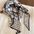 Close-up of white paisley print fabric scarf necklace with elegant silk-like texture - Black-White Floral Necklace