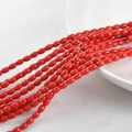 Macro shot of vibrant red oval synthetic turquoise beads on a white tray for DIY jewelry - 4*6mm (Approx. 60pcs) / Red