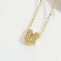 Chic gold necklace with U-shaped pendant featuring micro-pave cubic zirconia on thin chain - Letter U