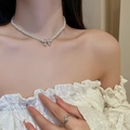 Close-up of elegant double-layered pearl necklace with diamond bow pendant and silver ring - 12# Necklace. White Faux Pearl Butterfly (Rhinestone Pendant)