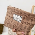 Brown corduroy cosmetic bag with floral patterns and a Time to Party label - Khaki Plants