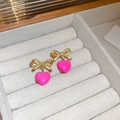 Elegant gold bow earrings with vibrant pink heart pendants in a velvet jewelry box - Pink Heart Bow Earrings (Steel Pin)