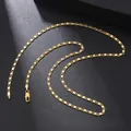 Detail of a gold-plated flat link necklace with a lobster clasp on a dark background - Flat Link Chain (10) / Gold