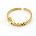 Macro shot of gold Pisces zodiac ring showing adjustable band and engraved lettering - Pisces / Gold