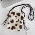 Detail showing the white plush heart pattern bag with its black and white braided strap - White Hearts