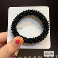 Elastic black beaded hair tie with sparkling faceted crystals on a display card - Black Crystal