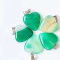 Green heart-shaped natural stone pendants with metal bails in various shades and textures - Green Agate