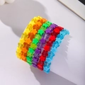 Pulseras de estrellas de acrílico de colores apiladas en un soporte cilíndrico blanco - D0125-1 (Juego de 6 Pulseras de Estrellas Color Caramelo)