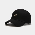 Close-up of golden embroidered H letter on a premium black cotton twill baseball cap - Adjustable / Black