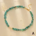Detail of turquoise stones and baroque pearl necklace on soft satin background - Turquoise Blue