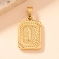 Macro shot of gold-plated rectangle pendant with embossed letter I and textured finish - Letter I