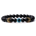 Detail of black beaded bracelet with golden crowns and blue evil eye charm - Obsidian (13)