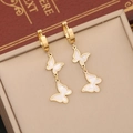 Elegant gold-plated double butterfly earrings with white shell inlay on a jewelry box - Golden Butterfly Rhinestone Earrings