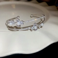 Macro shot of silver-tone layered floral cuff bracelet with pearls and pavé cubic zirconia - Double Layer Zirconia Pearl Flower Cuff
