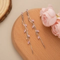 Detail of silver leaf tassel earrings with pink marquise gemstones on wooden base - Silver-Pink Zirconia